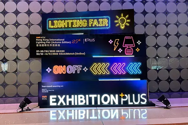 Colorful neon signs illuminate the Hong Kong International Lighting Fair Autumn Edition, featuring event dates from October 23 to 26, 2023, with 'Exhibition Plus' and 'On Off' displays.