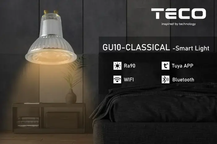 White GU10 smart LED bulb emitting warm light in a modern room with plants and furniture, displaying TECOCO branding and features such as Ra90 CRI, Tuya app control, WiFi, and Bluetooth connectivity.