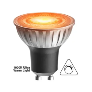 Close-up of a GU10 LED bulb emitting warm orange-yellow light from its frosted dome, labeled as 1000K ultra warm with dimmable symbol.