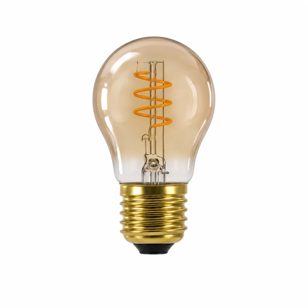 Close-up of an amber glass light bulb with orange spiral filament and gold metal base on white background.