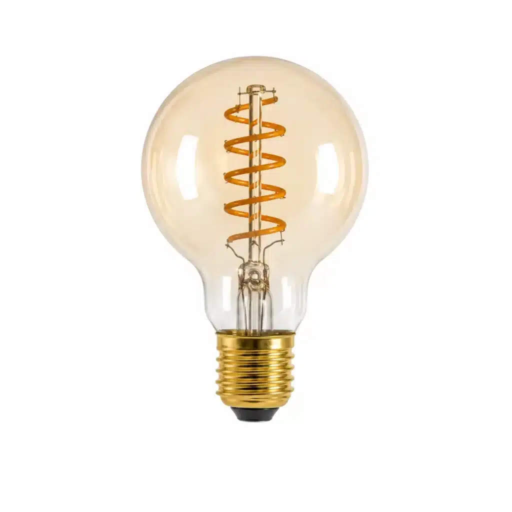 A vintage-style light bulb with a spiral orange filament inside a round amber glass globe and a gold base.
