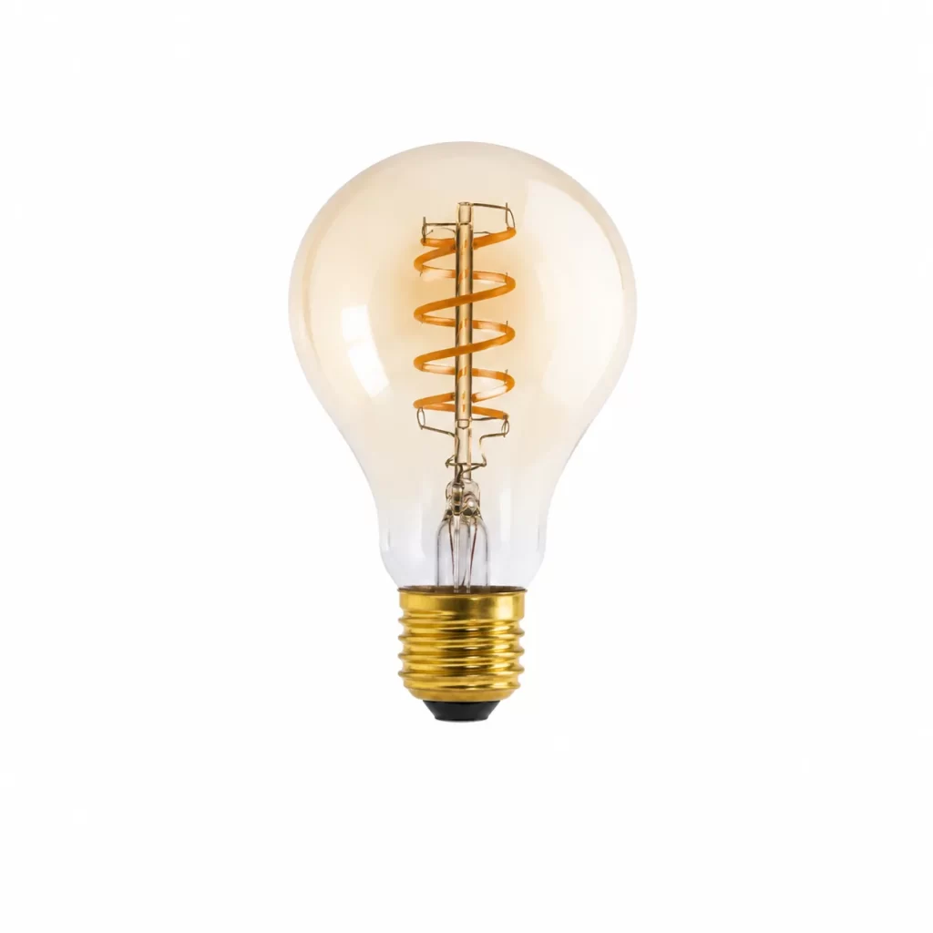 Close-up of a transparent light bulb with a glowing spiral filament and golden screw base against a plain white backdrop.