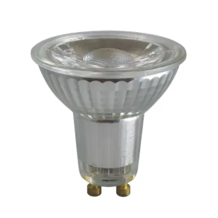 Close-up of a transparent glass GU10 light bulb with ribbed reflector and two metal pins at the base.