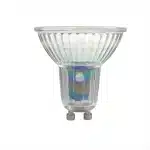 A clear glass GU10 LED bulb with a faceted reflector showing iridescent rainbow colors and two metal pins at the base.