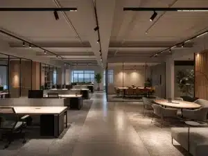 Spacious modern office with open workstations, glass conference room, lounge seating, track lighting, and neutral contemporary decor.