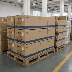 Large stacks of TECO branded cardboard boxes placed on wooden pallets in an industrial warehouse setting.